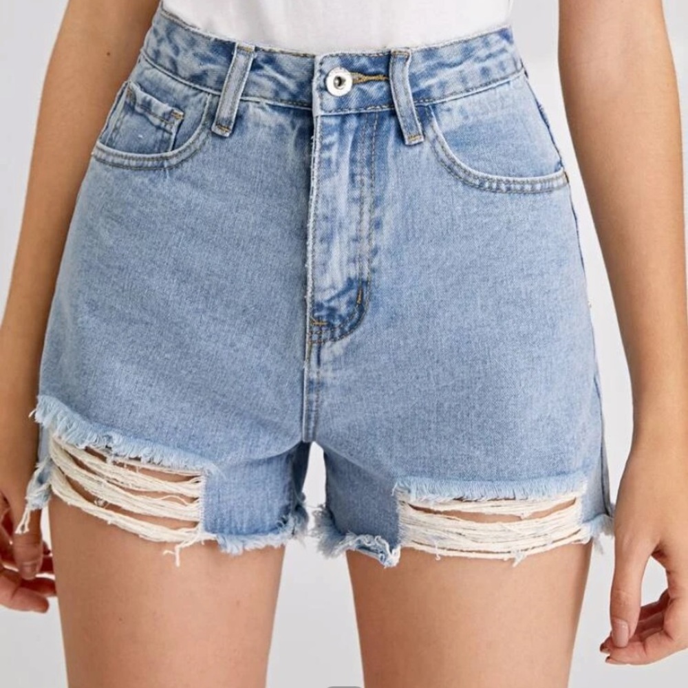 High wasted, denim shorts with a light wash.